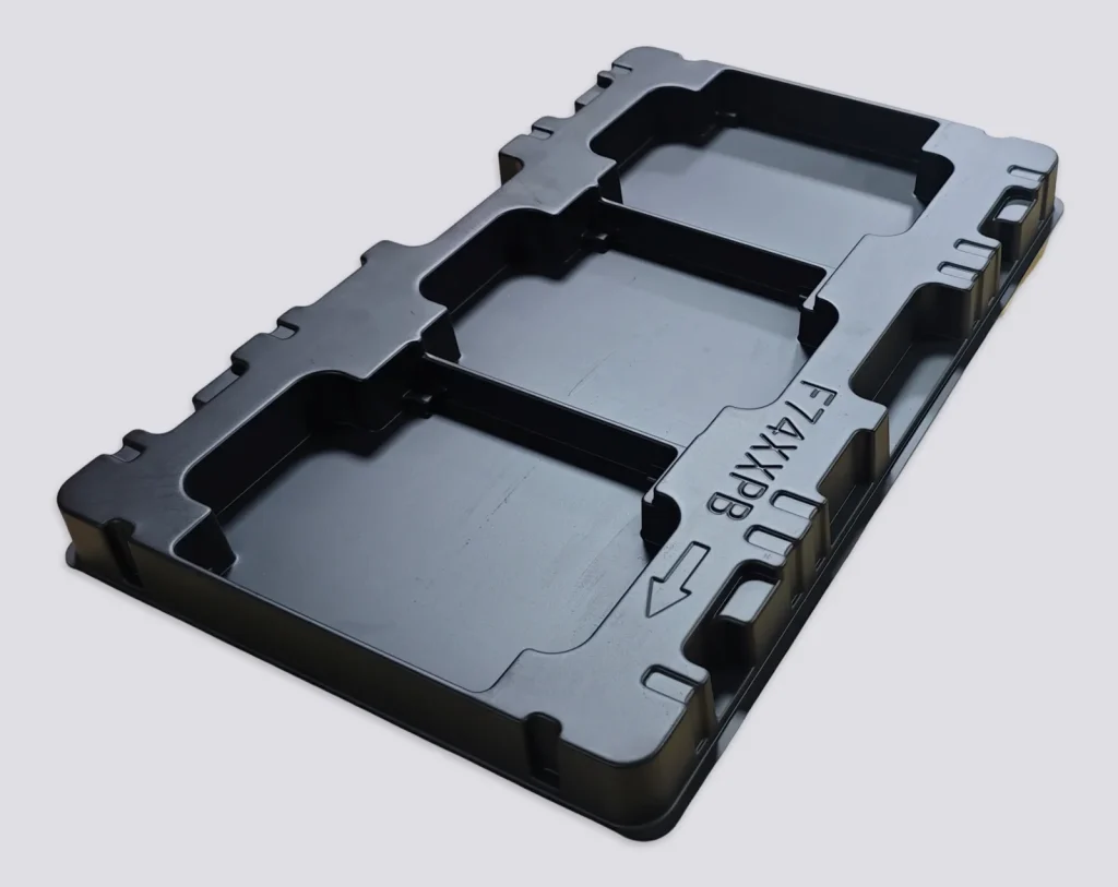 black thermoformed tray with formed cavities for electronic modules